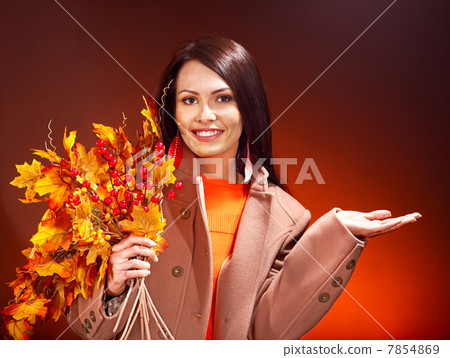 Woman holding  orange leaves. 7854869