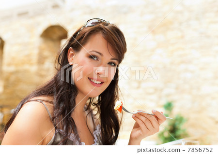Woman eating food in the afternoon Woman eating food in the afternoon 7856752