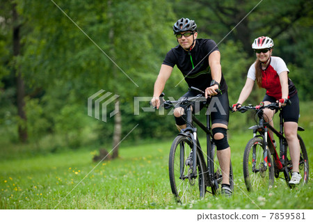 Man and woman riding bicycles Man and woman riding bicycles 7859581