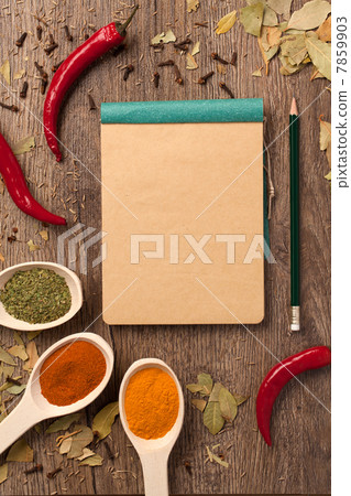 peppers, spices in spoons, notebook and pencil peppers, spices in spoons, notebook and pencil 7859903