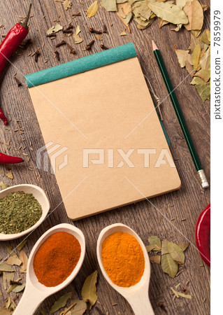 Old notebook, spices in spoons Old notebook, spices in spoons 7859979