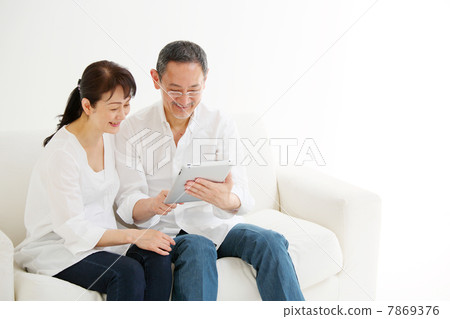 Senior couple using iPad Senior couple using iPad 7869376