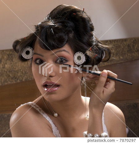Woman applying makeup  7870297