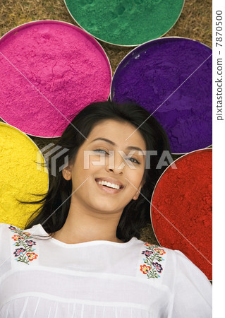 Woman lying with trays of gulal  7870500