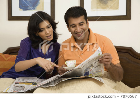 Couple looking at the morning newspaper  7870567