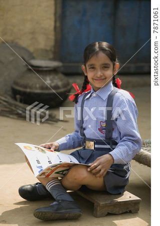 A rural school girl sitting with her boo A rural school girl sitting with her boo 7871061