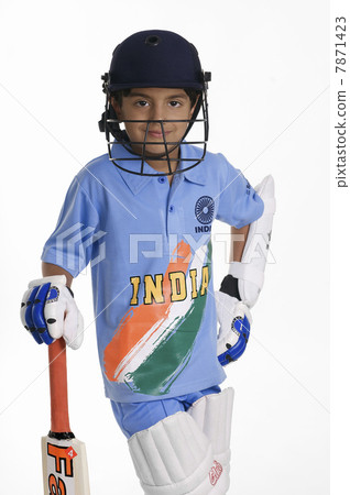 A boy in a cricketer's outfit  7871423