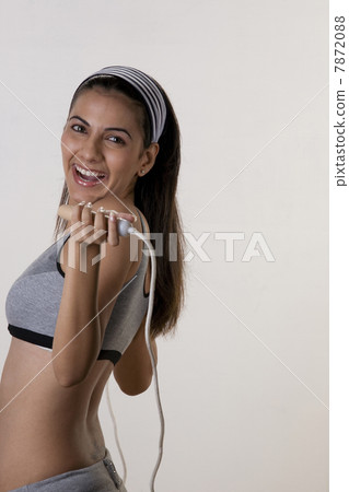 Woman posing with skipping rope Woman posing with skipping rope 7872088