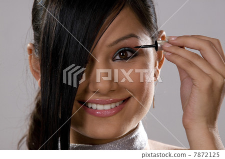 Woman applying make-up Woman applying make-up 7872125