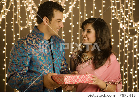 Couple exchanging presents Couple exchanging presents 7873415