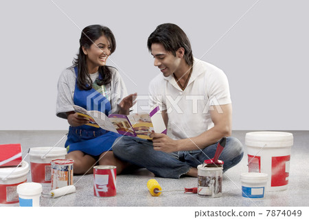 Couple with a paint brochure Couple with a paint brochure 7874049