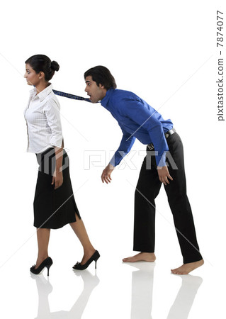 Businesswoman pulling a businessman's tie  7874077