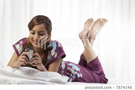 Woman looking at her cell phone Woman looking at her cell phone 7874148