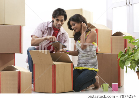 Couple looking at a photo frame Couple looking at a photo frame 7874254