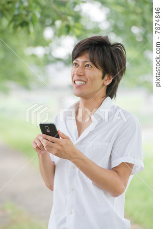 Male in her 20s with smartphone Male in her 20s with smartphone 7874846