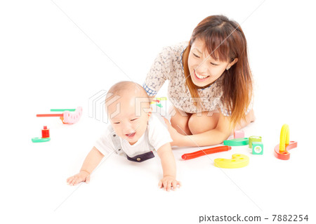 Energetic baby playing with mum with a block 7882254
