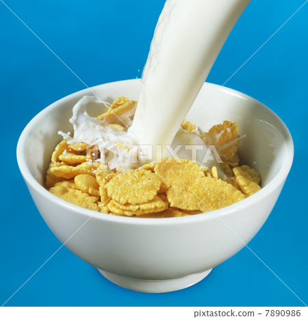 Milk pouring in a bowl of cornflakes Milk pouring in a bowl of cornflakes 7890986