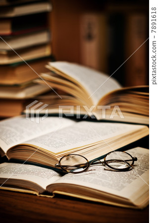 opened book, lying on the bookshelf opened book, lying on the bookshelf 7891618