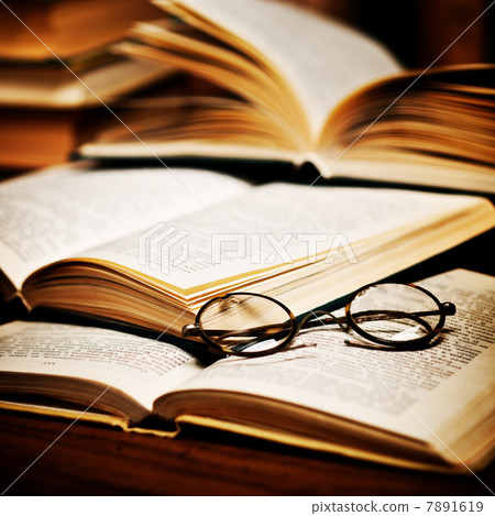 opened book, lying on the bookshelf opened book, lying on the bookshelf 7891619