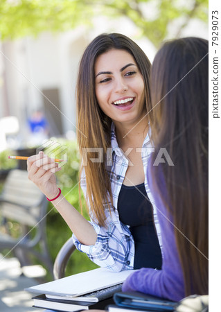 Expressive Young Mixed Race Female Sitting and Talking with Girl 7929073