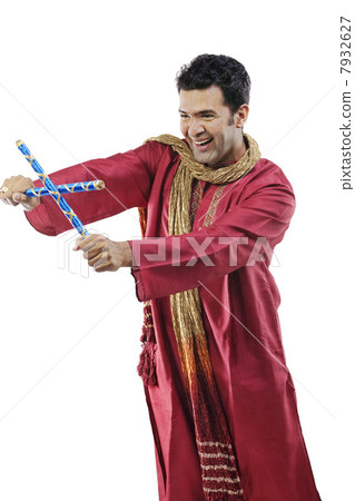 Gujarati man with dandiya sticks Gujarati man with dandiya sticks 7932627