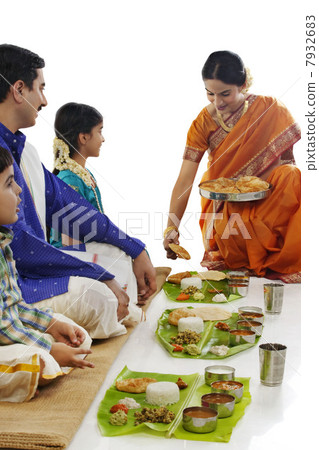 South Indian woman serving food to her family South Indian woman serving food to her family 7932683
