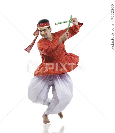 Gujarati man performing dandiya 7932809