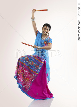 Gujarati woman with dandiya sticks 7932810