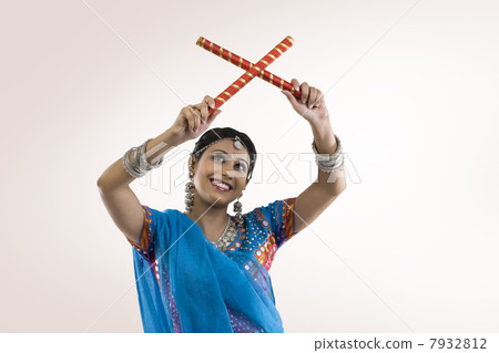 Gujarati woman with dandiya sticks 7932812