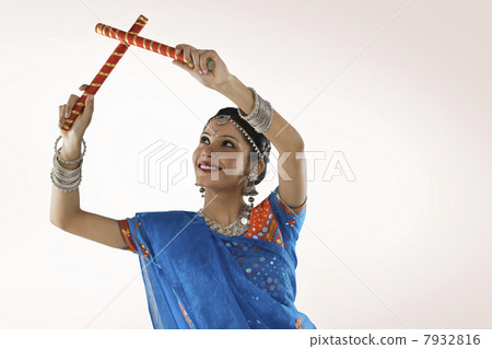 Gujarati woman performing dandiya Gujarati woman performing dandiya 7932816