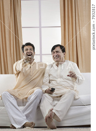 Father and son watching television 7932817