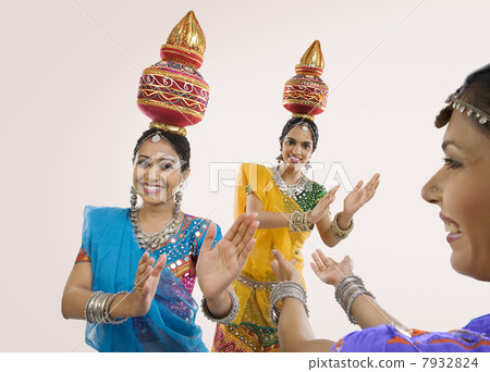 Gujarati women dancing with a kalash on their head Gujarati women dancing with a kalash on their head 7932824