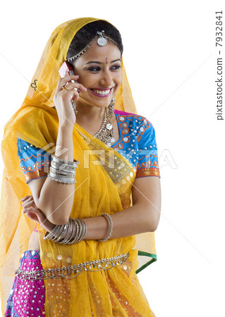Gujarati woman talking on a mobile phone Gujarati woman talking on a mobile phone 7932841