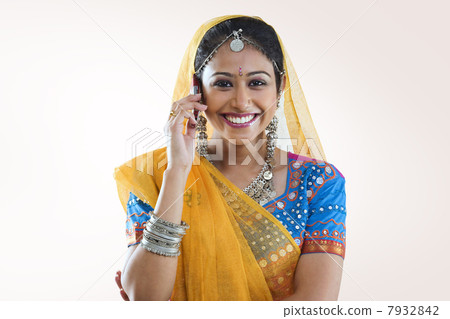 Gujarati woman talking on a mobile phone Gujarati woman talking on a mobile phone 7932842