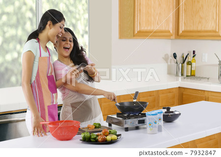 Mother and daughter cooking in the kitchen Mother and daughter cooking in the kitchen 7932847