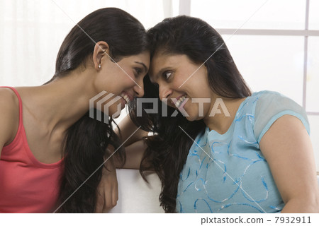 Mother and daughter looking eye to eye Mother and daughter looking eye to eye 7932911