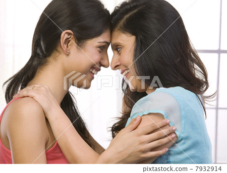 Mother and daughter looking face to face Mother and daughter looking face to face 7932914