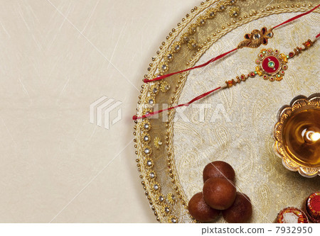 Rakhi , diya and sweets in a tray Rakhi , diya and sweets in a tray 7932950