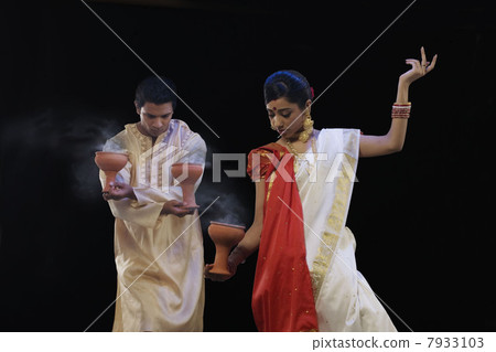 Bengali couple doing a Dhunuchi dance Bengali couple doing a Dhunuchi dance 7933103