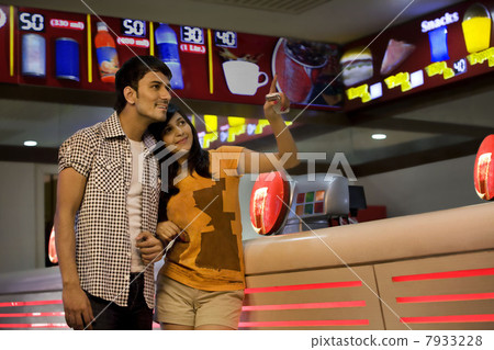 Girl pointing something out to her boyfriend 7933228