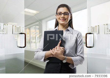 Secretary holding a laptop in the office 7933396