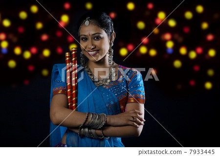 Gujarati woman with dandiya sticks 7933445