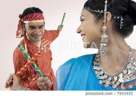 Gujarati couple performing dandiya 7933455