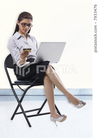 Secretary with a credit card and laptop 7933476