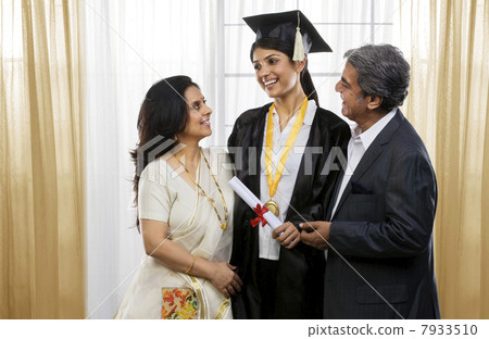 Parents congratulating their graduated daughter Parents congratulating their graduated daughter 7933510