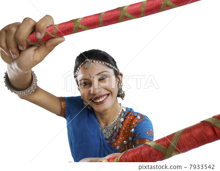Gujarati woman performing dandiya Gujarati woman performing dandiya 7933542