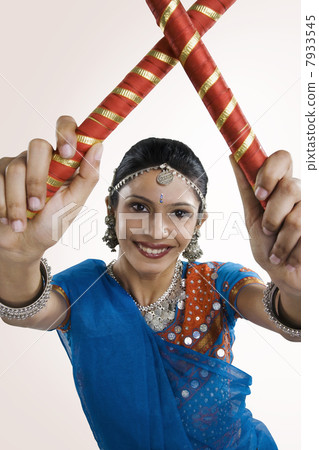 Gujarati woman performing dandiya Gujarati woman performing dandiya 7933545
