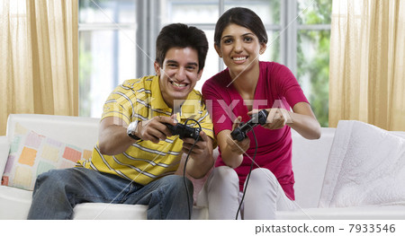 Brother and sister playing video games Brother and sister playing video games 7933546