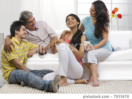 Family sitting together in the living room Family sitting together in the living room 7933678