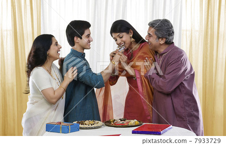Brother feeding his sister during Rakhi 7933729